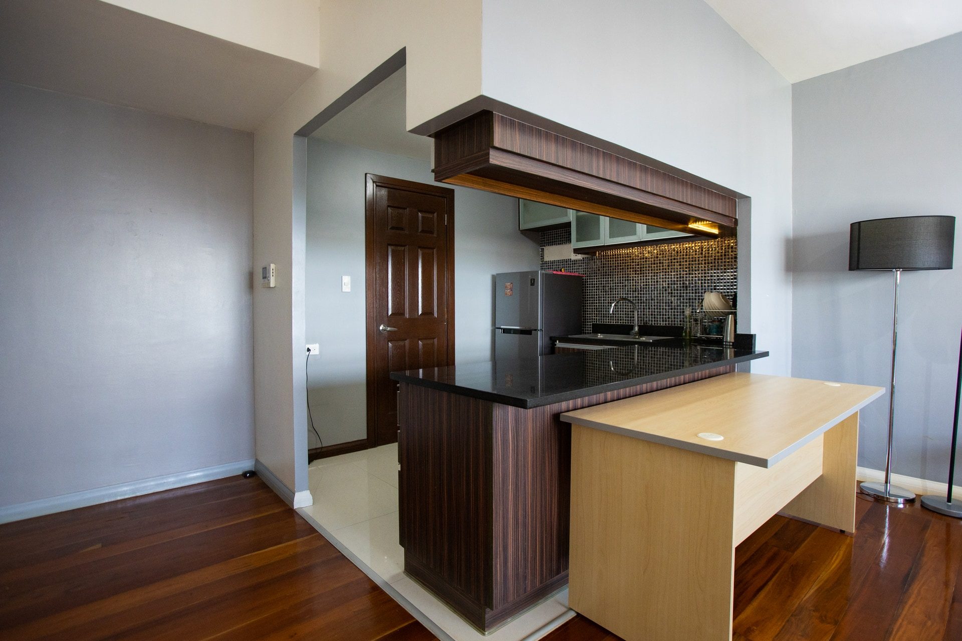 Apartment 1809 kitchen counter and wood-finished breakfast area opening onto the living room