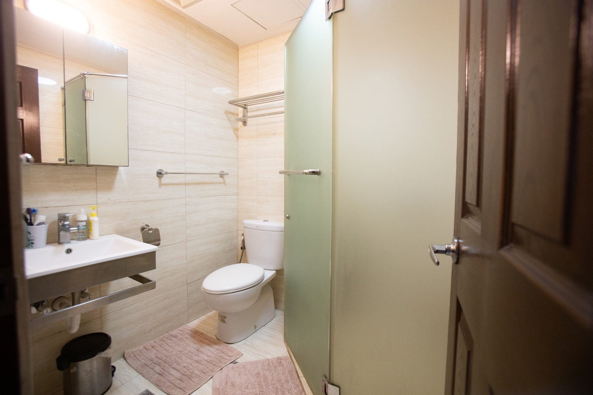 Apartment 1810 tiled shower room with a frosted-glass enclosure